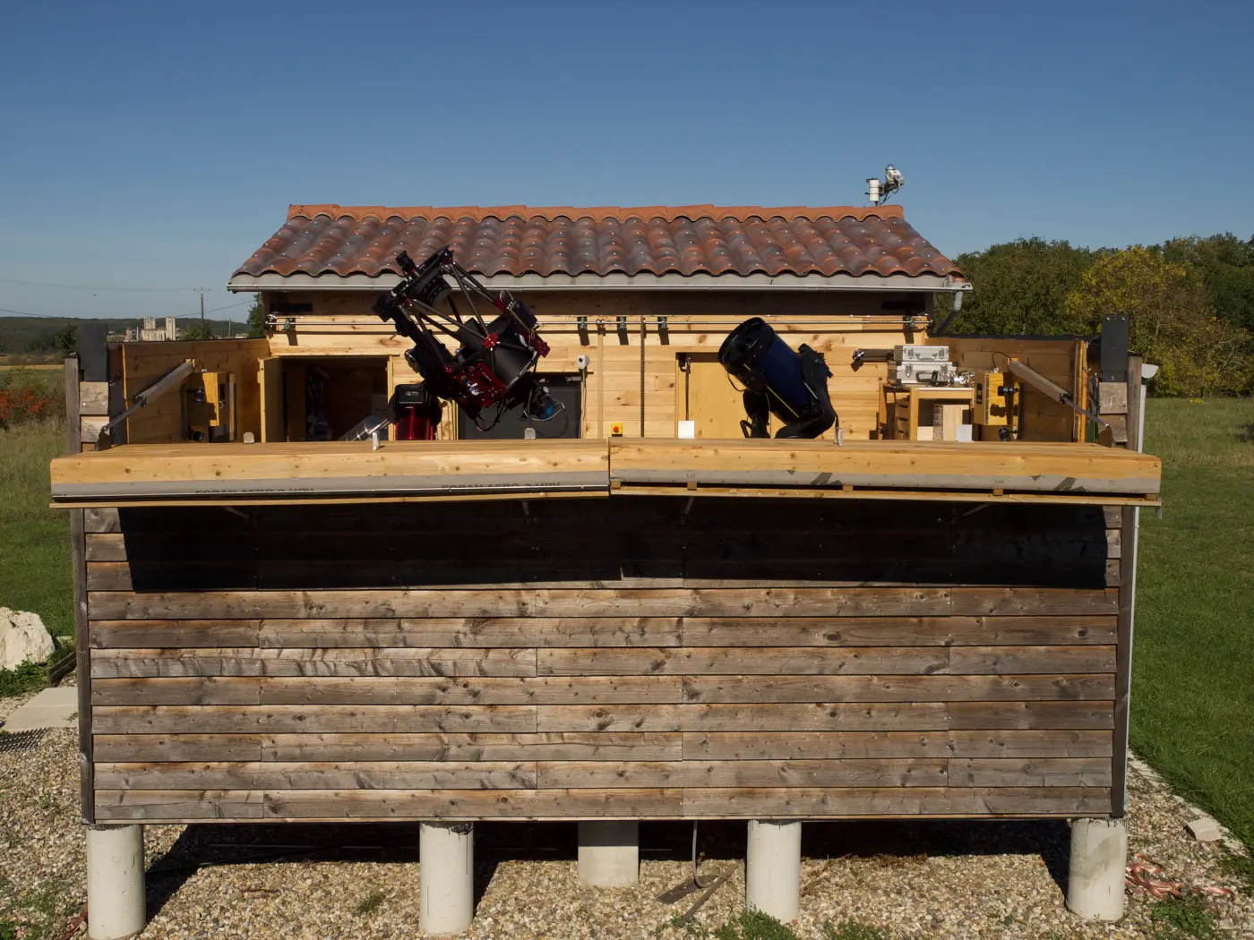 Le Bourdieu Observatory with its roll-off roof open and telescopes on their mounts